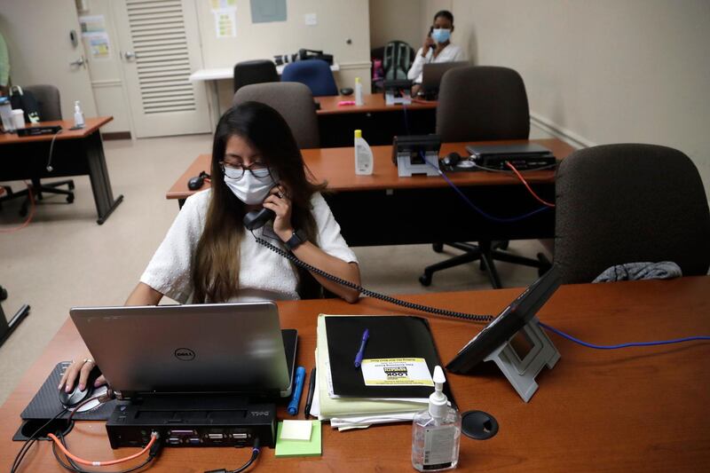 A worker takes a call at the Florida Department of Health in Miami-Dade County, US. AP Photo
