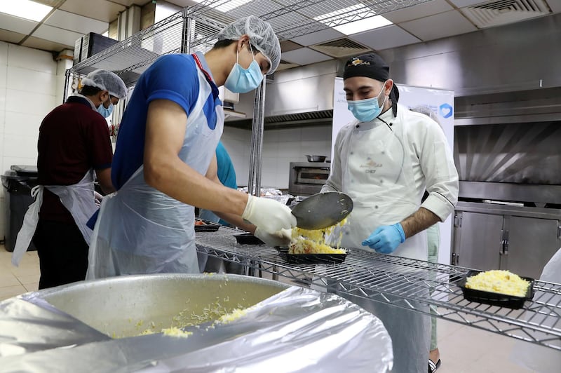 DUBAI, UNITED ARAB EMIRATES , May 01 – 2020 :- Staff of Al Nadeg restaurant in Deira Dubai preparing the food packets to deliver at the labour camp in Al Muhaisnah area in Dubai. This is a part of Mohammed Bin Rashid Al Maktoum 10 Million Meals Global Initiative. Volunteers from Beit Al Khair Society will distribute the food packets in the labour camps. Today they are delivering 1000 food packets from Al Nadeg restaurant. Total 12000 food packets will be deliver in different labour camps in Dubai. (Pawan Singh / The National) For News/Online/Instagram. Story by Anam