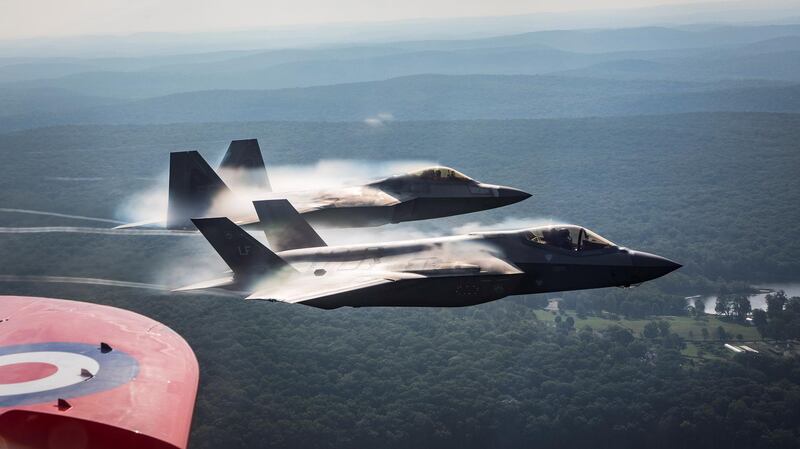 U.S. Air Force F-35 and F-22 aircraft accompany the Red Arrows.  Reuters