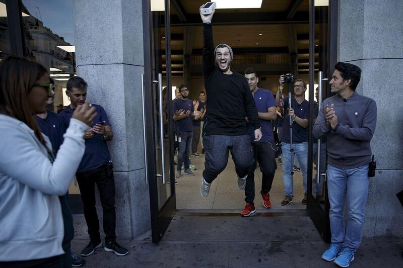 Alex Torodache, one of the first customers to buy iPhone 7 celebrates at Puerta del Sol Apple Store in Madrid, on September 16, 2016, the day the company launched the device, as well as the 7 Plus, in the city. The phones went on sale Friday in more than 25 countries. Customers started to queue 38 hours before the store opened. Gonzalo Arroyo Moreno / Getty Images