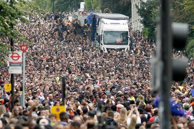 FILE - In this Monday, Aug. 27, 2018 file photo, crowds on Ladbroke Grove take part in the parade during the Notting Hill Carnival in London. Organizers of the Notting Hill Carnival, Europe's biggest street fair, on Friday June 18, 2021, are taking the event off the streets for the second year in a row because of the COVID-19 pandemic. (AP Photo/Tim Ireland, File)