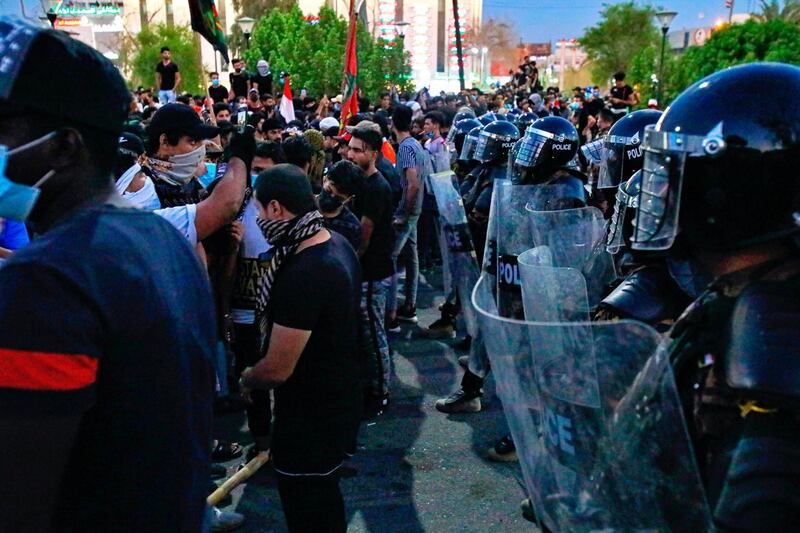 Demonstrators burned the outer gate of the entrance to the parliament building. AP