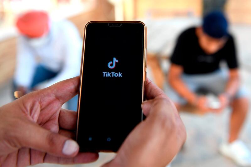 Indian mobile users browses through the Chinese owned video-sharing 'Tik Tok' app on a smartphones in Amritsar on June 30, 2020. TikTok on June 30 denied sharing information on Indian users with the Chinese government, after New Delhi banned the wildly popular app citing national security and privacy concerns.
"TikTok continues to comply with all data privacy and security requirements under Indian law and have not shared any information of our users in India with any foreign government, including the Chinese Government," said the company, which is owned by China's ByteDance.
 / AFP / NARINDER NANU
