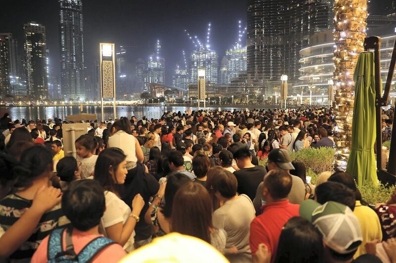 DUBAI ,  UNITED ARAB EMIRATES , JUNE 12 – 2019 :- People gathered to see Burj Khalifa which will be displaying a projection of the Philippines flag for the first time ever in commemoration of Philippines National Day at Dubai Mall in Dubai. ( Pawan Singh / The National ) For News