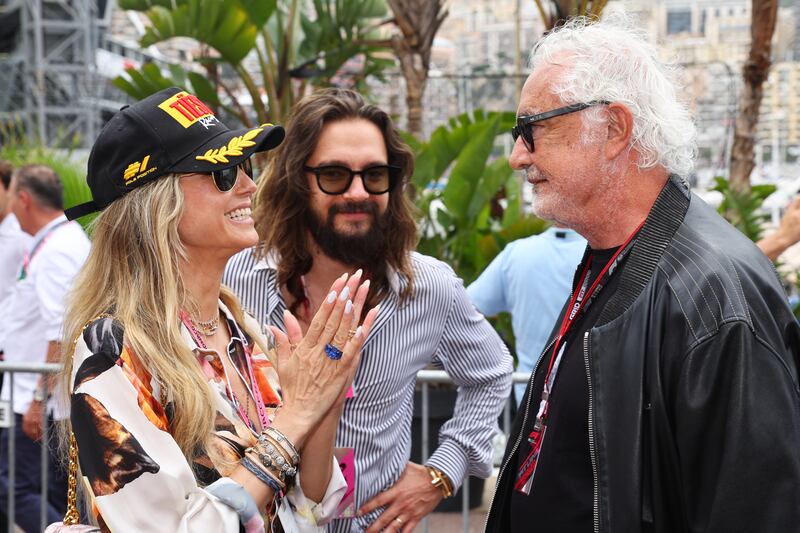 Heidi Klum and Tom Kaulitz talk to Flavio Briatore. Getty