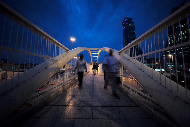 Workers cross the pedestrian bridge during rush hour from Bahrain Financial Harbour to downtown Manama, Bahrain. Reuters