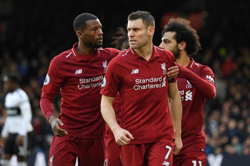 LONDON, ENGLAND - MARCH 17:  James Milner of Liverpool celebrates with his teammates after he scores his sides second goal from the penalty spot  during the Premier League match between Fulham FC and Liverpool FC at Craven Cottage on March 17, 2019 in London, United Kingdom. (Photo by Michael Regan/Getty Images)