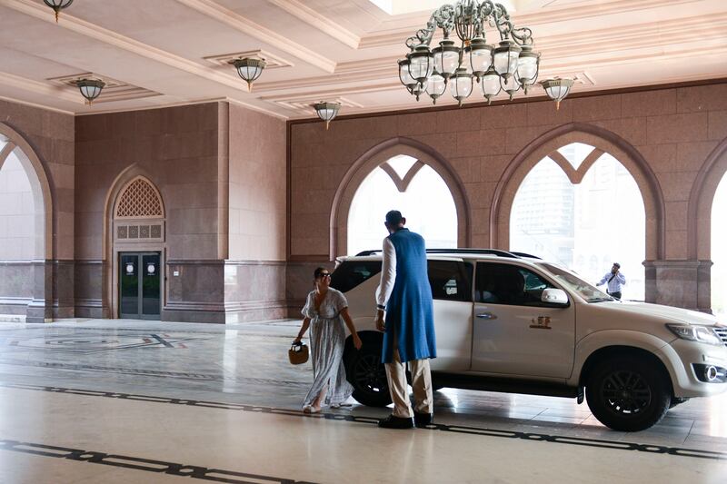 Abdul Jabbar Fazal, 50, who is 2.26m tall and from Lahore, Pakistan, greets guests outside Emirates Palace, Abu Dhabi. Khushnum Bhandari / The National
