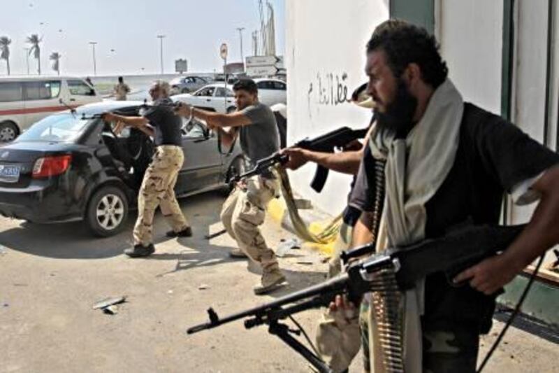 Libyan rebel fighters fire towards forces loyal to Moammar Gadhafi during fierce gunfire in downtown Tripoli, Libya, Monday, Aug. 22, 2011. World leaders said Monday the end is near for Moammar Gadhafi's regime and began planning for Libya's future without the man who has held power there for 42 years. (AP Photo/Sergey Ponomarev) *** Local Caption ***  APTOPIX Mideast Libya.JPEG-057e6.jpg