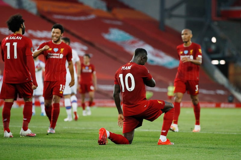 LIVERPOOL, ENGLAND - JUNE 24: Sadio Mane of Liverpool celebrates by taking a knee after he scores his sides fourth goal during the Premier League match between Liverpool FC and Crystal Palace at Anfield on June 24, 2020 in Liverpool, England. (Phil Noble/Pool via Getty Images)