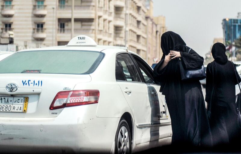 A Saudi woman prepares to get into a taxi on a main street in the Saudi coastal city of Jeddah on September 27, 2017.
Saudi Arabia will allow women to drive from next June, state media said on September 26, 2017 in a historic decision that makes the Gulf kingdom the last country in the world to permit women behind the wheel. 
The shock announcement comes after a years-long resistance from women's rights activists, some of whom were jailed for defying the ban on female driving. / AFP PHOTO / AMER HILABI