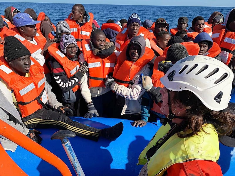 In this photo taken on Saturday, Jan. 19, 2019, rescued migrants are assisted by Sea-Watch rescue ship's personnel in the Mediterranean Sea. A private rescue boat with dozens of migrants aboard sought permission for a second day to enter a safe port Sunday, but said so far its queries to several nations haven't succeeded. Another vessel crowded with panicking migrants and taking on water, meanwhile, put out an urgent, separate appeal for help in the southern Mediterranean. Sea-Watch 3, run by a German NGO, said Sunday it has contacted Italy, Malta, Libya as well as the Netherlands, since the boat is Dutch-flagged, asking where it can bring the 47 migrants it had taken aboard. Sea-Watch tweeted that Libyan officials had hung up when it asked for a port assignment. (Doug Kuntz/Sea-Watch via AP)