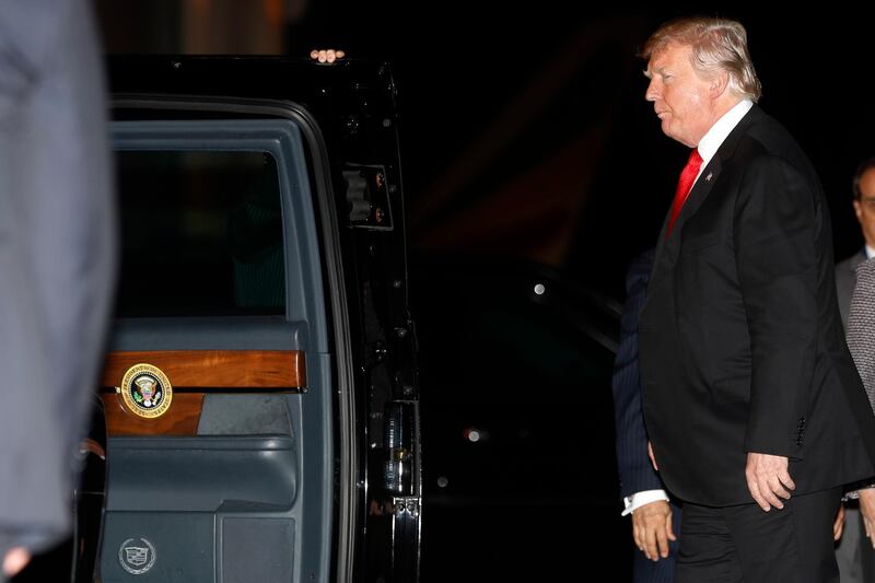 President Donald Trump walks to his motorcade vehicle as he arrives on Air Force One. AP Photo