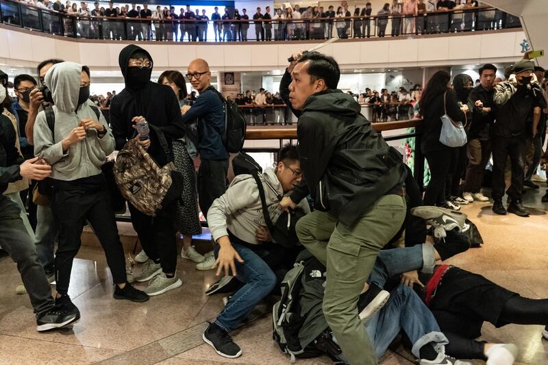 Plain clothes police react during a clash with protesters in a shopping mall on December 24, 2019 in Hong Kong, Anthony Kwan/Getty Images