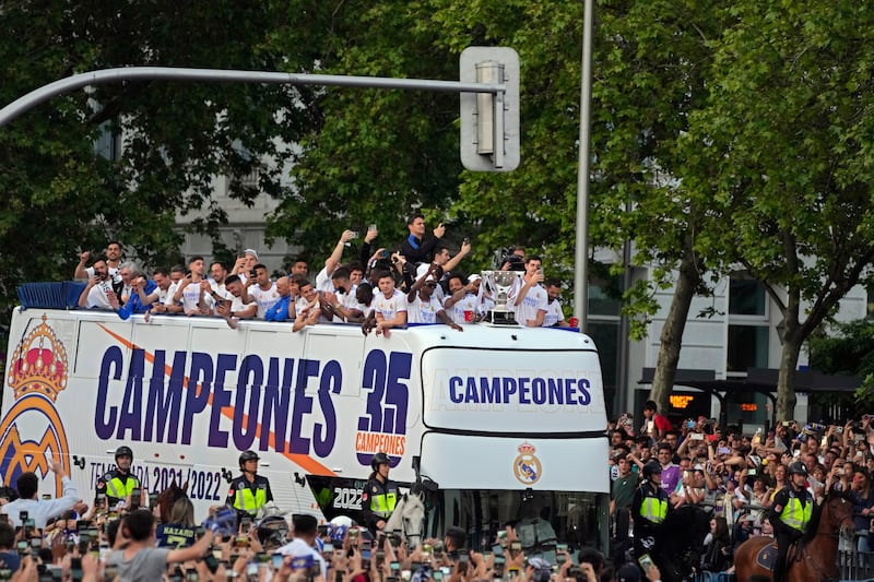 Real Madrid players celebrate on an open top bus after winning La Liga as thousands of fans turn out on the streets of Madrid. AP