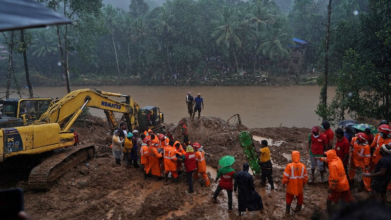 Rescue workers carry the body of a victim, recovered from a house swept by a landslide at Kokkayar village, in Idukki district. Reuters