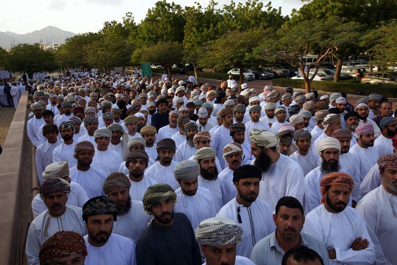 People gather in front of the Sultan Qaboos Mosque to perform funeral prayers. AFP