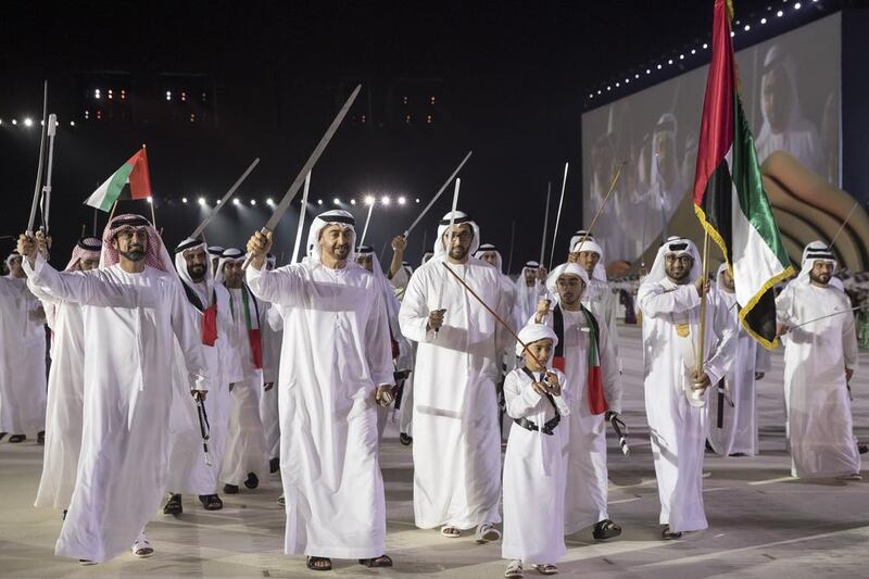 Sheikh Mohammed bin Zayed dances during the 45th UAE National Day celebrations at Abu Dhabi National Exhibition Centre (Adnec). Seen with Sheikh Ammar bin Humaid Al Nuaimi, Crown Prince of Ajman (L), Sheikh Tahnoon bin Mohammed (bottom R), and Sheikh Rashid bin Saud, Crown Prince of Umm Al Quwain (back centre R). Ryan Carter / Crown Prince Court — Abu Dhabi