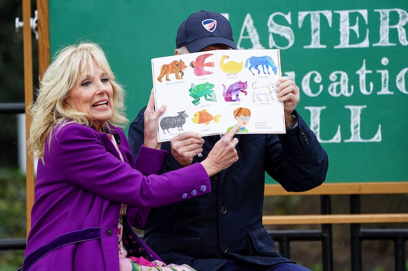 First Lady Jill Biden reads to youngsters with her husband’s help. EPA