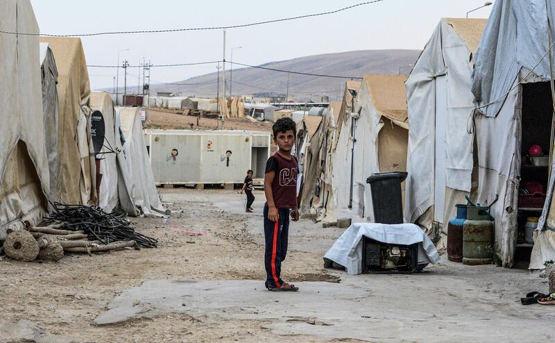 A boy stands in an alley between tents at a camp for internally displaced persons (IDP) of Iraq's Yazidi minority in the Sharya area, some 15 kilometres from the northern city of Dohuk in the autonomous Iraqi Kurdistan region.  AFP