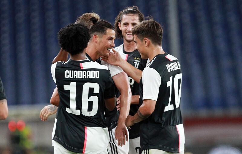 Cristiano Ronaldo, centre, celebrates with teammates after scoring Juventus' second goal against Genoa. AP Photo