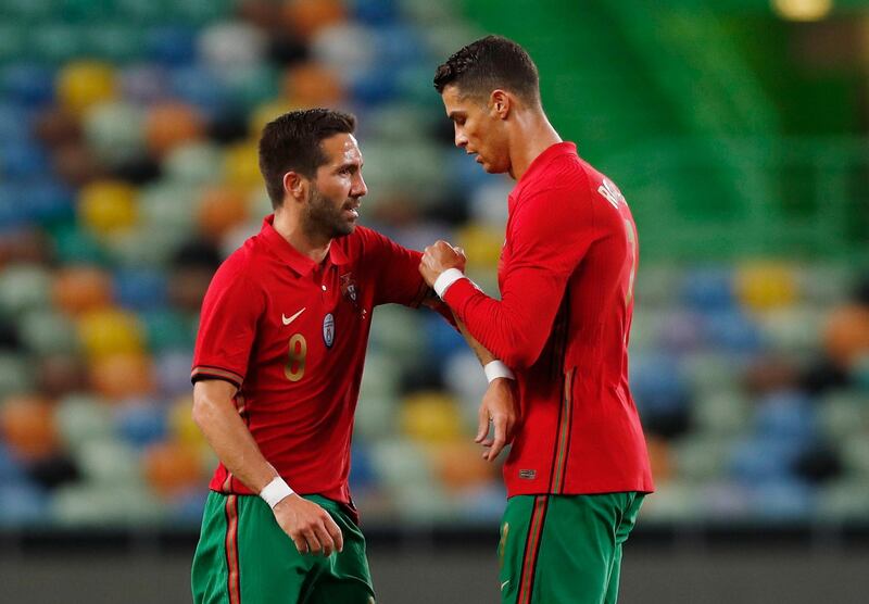 Portugal's Cristiano Ronaldo shakes hands with Joao Moutinho as he walks off to be substituted. Reuters