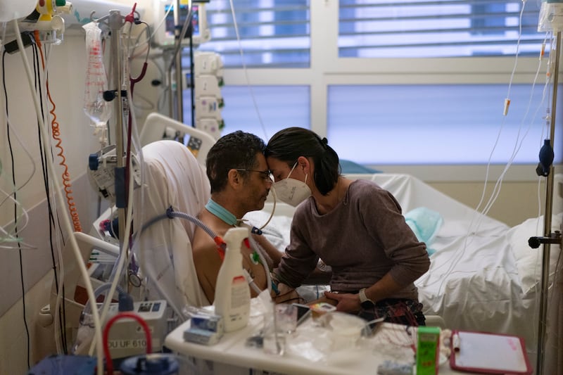 Amelie and Ludo Khayat hold each other during a visit at the Covid-19 unit of Marseille University Hospital Timone, in Marseille, southern France.  Ludo, 41, is recovering after spending 24 days in a coma. AP Photo