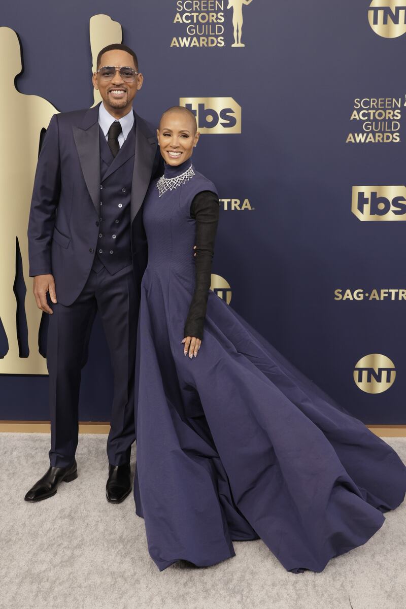 Will Smith and Jada Pinkett Smith arrive in matching navy outfits. AFP