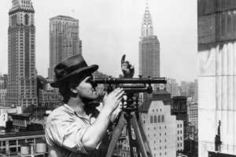 circa 1931:  A profile of an engineer peering through a level high above New York City during the construction of the Empire State Building.  The Chrystler building stands in the background. (Photo by Lewis W. Hine/George Eastman House/Getty Images) *** Local Caption ***  3172523.jpg