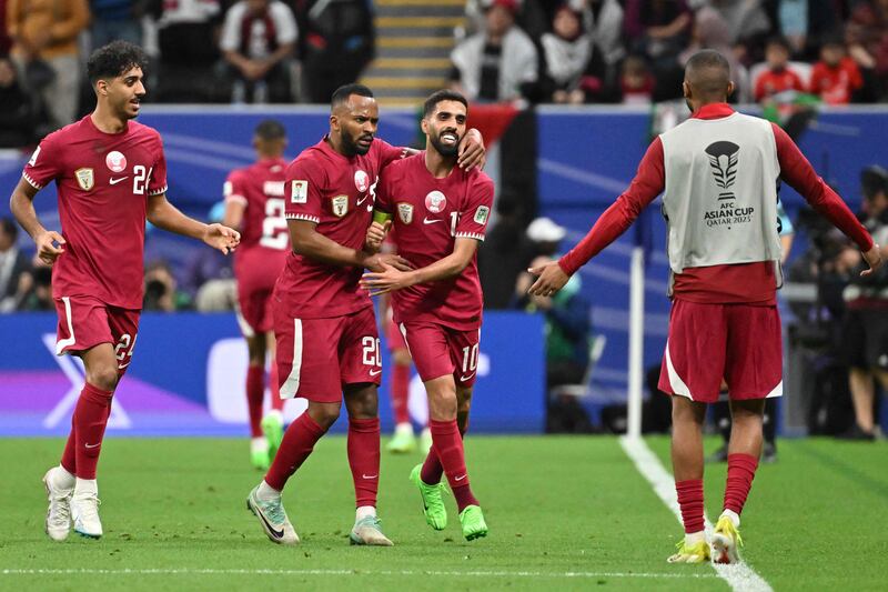 Qatar's Hassan Al Haydos celebrates with teammates after scoring. AFP