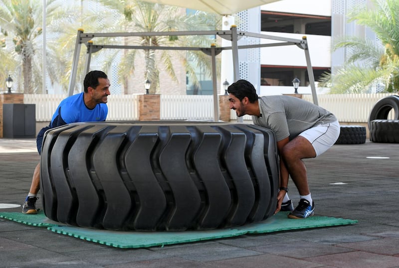 Nasser Al Ketbi-AD Nasser Al Ketbi, 23, works out with his guardian and mentor Hand Esaad, 50 at the Abu Dhabi Country Club on May 24, 2021. Khushnum Bhandari / The National 
Reporter: Haneen Dajani News