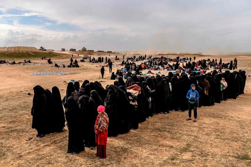 TOPSHOT - Civilians evacuated from the Islamic State (IS) group's embattled holdout of Baghouz wait at a screening area held by the US-backed Kurdish-led Syrian Democratic Forces (SDF), in the eastern Syrian province of Deir Ezzor, on March 5, 2019. Kurdish-led forces launched a final assault Friday on the last pocket held by the Islamic State group in eastern Syria, their spokesman said. The "operation to clear the last remaining pocket of ISIS has just started", Mustefa Bali, the spokesman of the US-backed Syrian Democratic Forces, said in a statement using an acronym for the jihadist group. - QUALITY REPEAT
 / AFP / Bulent KILIC / QUALITY REPEAT

