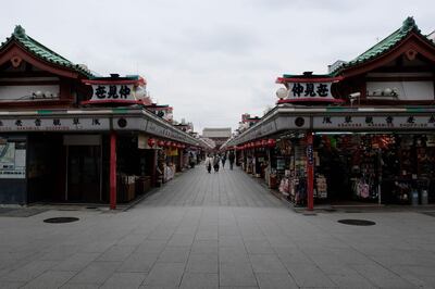 Shops along a near-deserted street are seen near the entrance of the Sensoji-temple in Tokyo on March 30, 2020, amid concerns of the COVID-19 coronavirus.  / AFP / Kazuhiro NOGI
