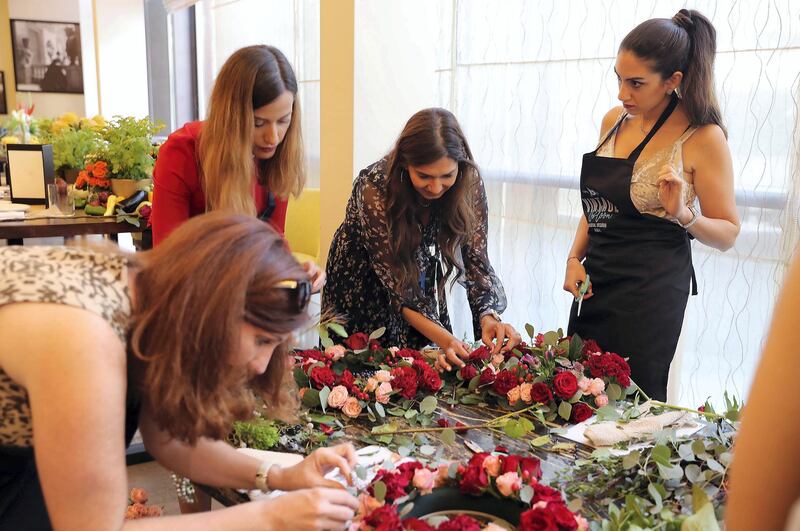 DUBAI , UNITED ARAB EMIRATES , DEC 04  – 2017:- Nada Gokal ( center ) from Vintage Bloom teaching during the wreath making organised by Vintage Bloom at the Four Seasons Hotel on Jumeirah Beach road in Dubai. (Pawan Singh / The National) Story by Hala Khalaf