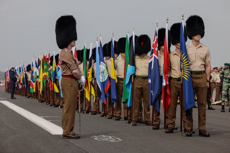 Flag bearers representing the Commonwealth nations and overseas territories await the start of the rehearsal. Getty