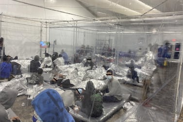 Migrants crowd a room with walls of plastic sheeting at the US Customs and Border Protection temporary processing center in Donna, Texas, in a recent photograph released by the Office of Congressman Henry Cuellar. Reuters