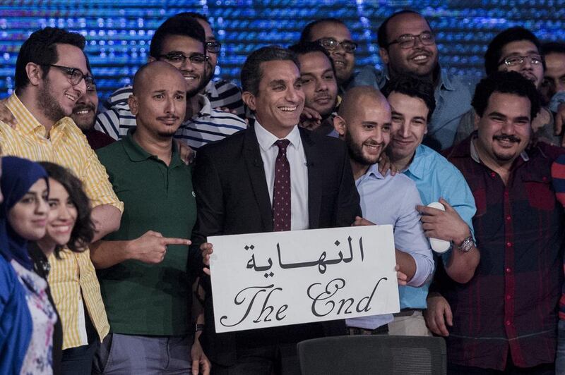 The Egyptian satirist and Al Bernameg host Bassem Youssef, centre, and his team announce the end of the show. Khaled Desouki / AFP
