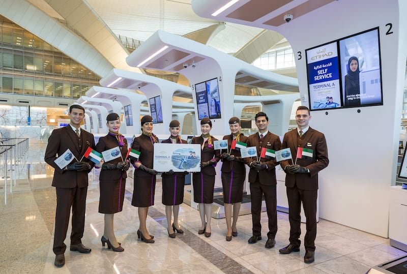 Etihad Airways cabin crew celebrate the launch of Terminal A, which covers 742,000 square metres, at check-in