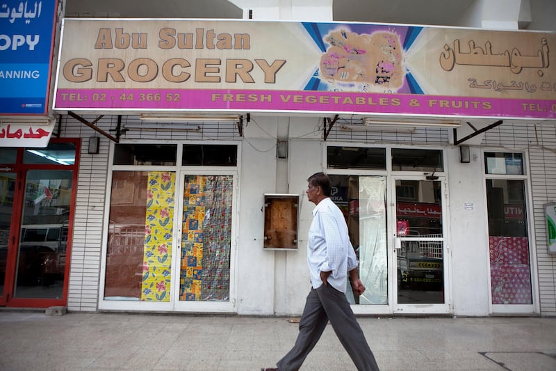 Abu Dhabi, United Arab Emirates, January 10, 2013: 
A man walks by the Abu Sultan Grocery, a recently closed convenience store on Thursday, Jan. 10, 2013, in the city block between Airport and Muroor, and Delma and Mohamed Bin Khalifa streets in Abu Dhabi. 
Silvia Razgova/The National

