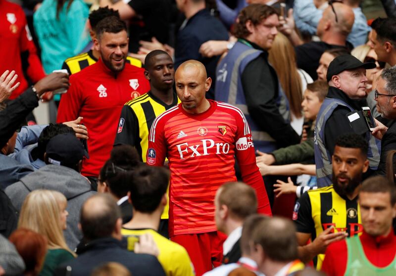 Watford's Heurelho Gomes, Abdoulaye Doucoure and teammates walk down the steps after receiving their losers medals. Reuters