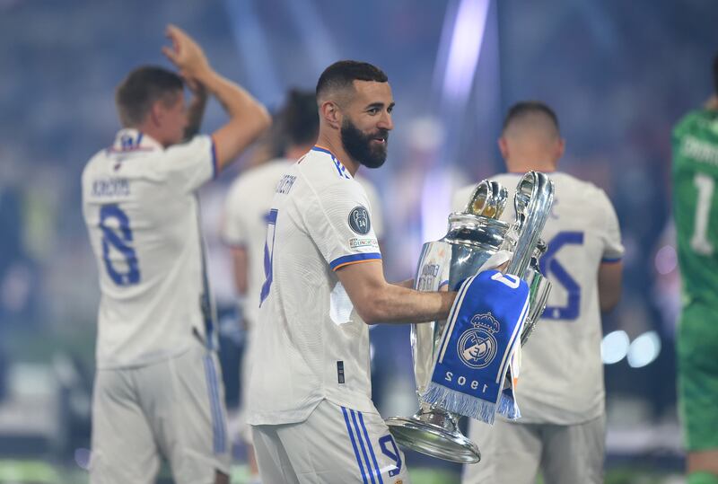 Karim Benzema holds the trophy during celebrations at Santiago Bernabeu. Getty