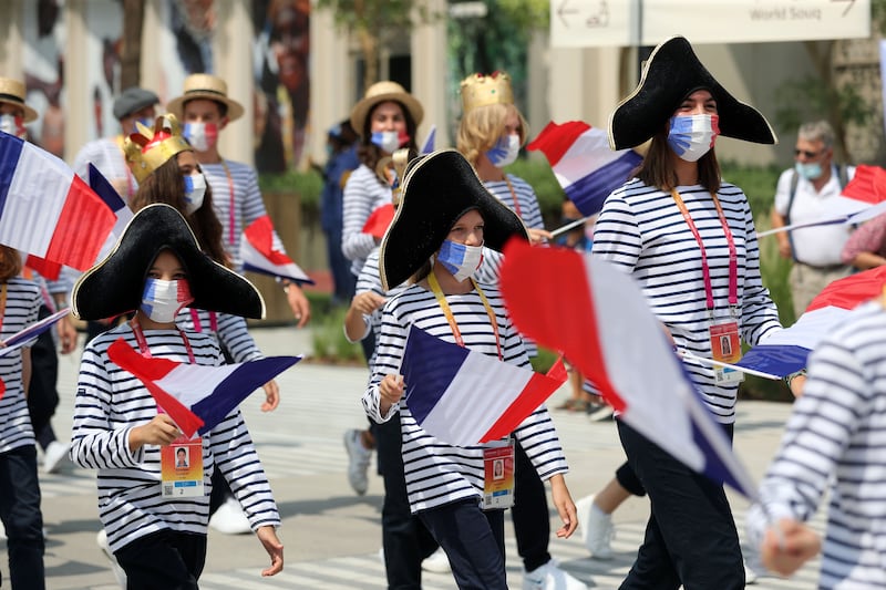 People parade on French national day at Expo 2020, Dubai. Chris Whiteoak / The National