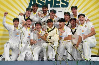 Australia's players celebrates with the trophy after defeating England on the third day of the fifth Ashes cricket Test match in Hobart on January 16, 2022.  (Photo by William WEST  /  AFP)  /  -- IMAGE RESTRICTED TO EDITORIAL USE - STRICTLY NO COMMERCIAL USE --