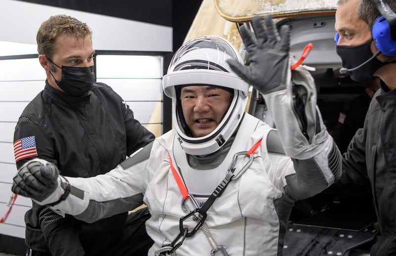 Japan Aerospace Exploration Agency astronaut Soichi Noguchi gives a wave as he is helped out of the SpaceX Crew Dragon. AP Photo