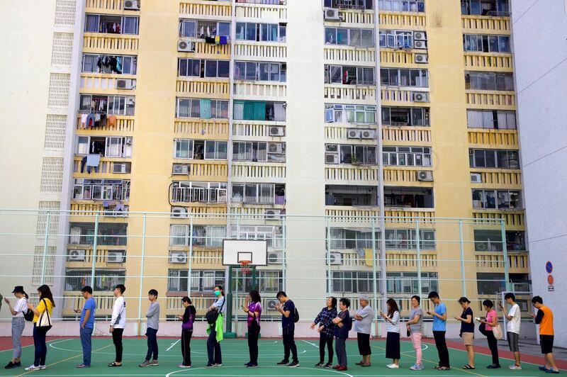 People queue to vote outside of a polling centre on a housing estate in Hong Kong. AP Photo
