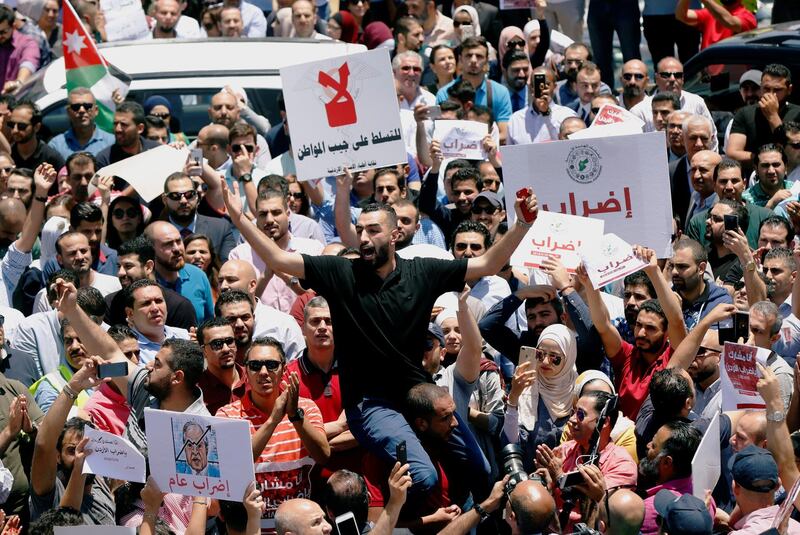 Jordanians chant slogans during a strike against the new income tax law in Amman. Muhammad Hamed / Reuters