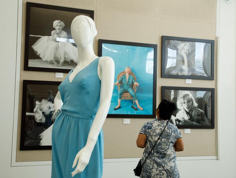 Photographs and a dress worn by the iconic actress Marilyn Monroe are shown on display during the press preview of 'Costumes and Artifacts from the Extraordinary Life of Marilyn Monroe' exhibition in Beverly Hills. EPA