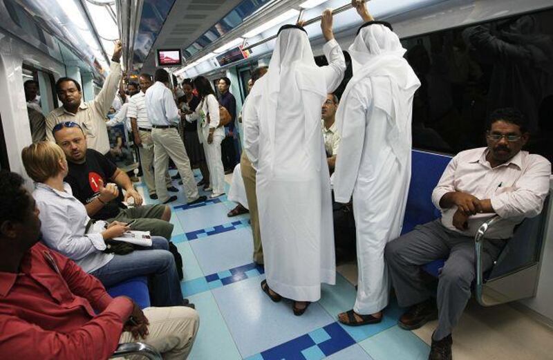 People travel on the first day of the Dubai Metro's public operation. The trains were carrying a full load of passengers by lunchtime.