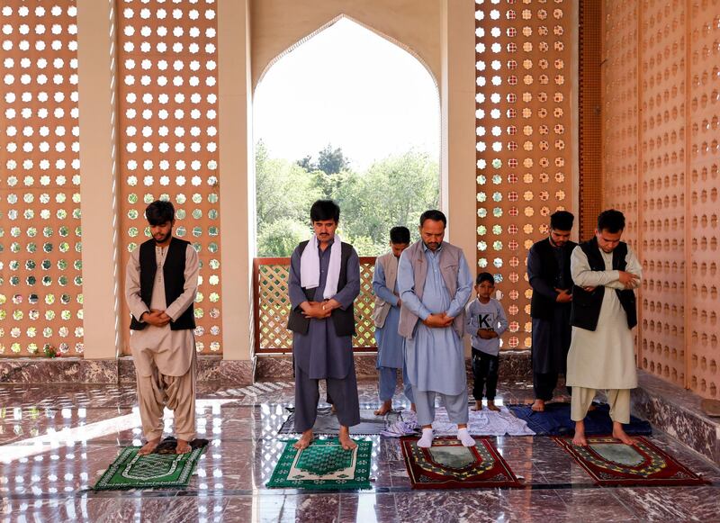 Afghan men take part in prayers during Eid Al Fitr at a mosque. REUTERS