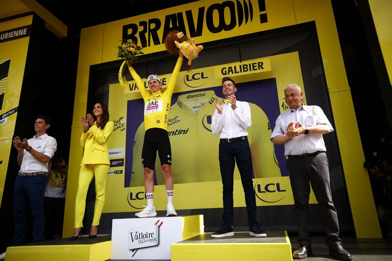 UAE Team Emirates rider Tadej Pogacar celebrates on the podium with the overall leader's yellow jersey after winning Stage 4 of the Tour de France between Pinerolo in Italy, and Valloire in France, on July 2, 2024. AFP